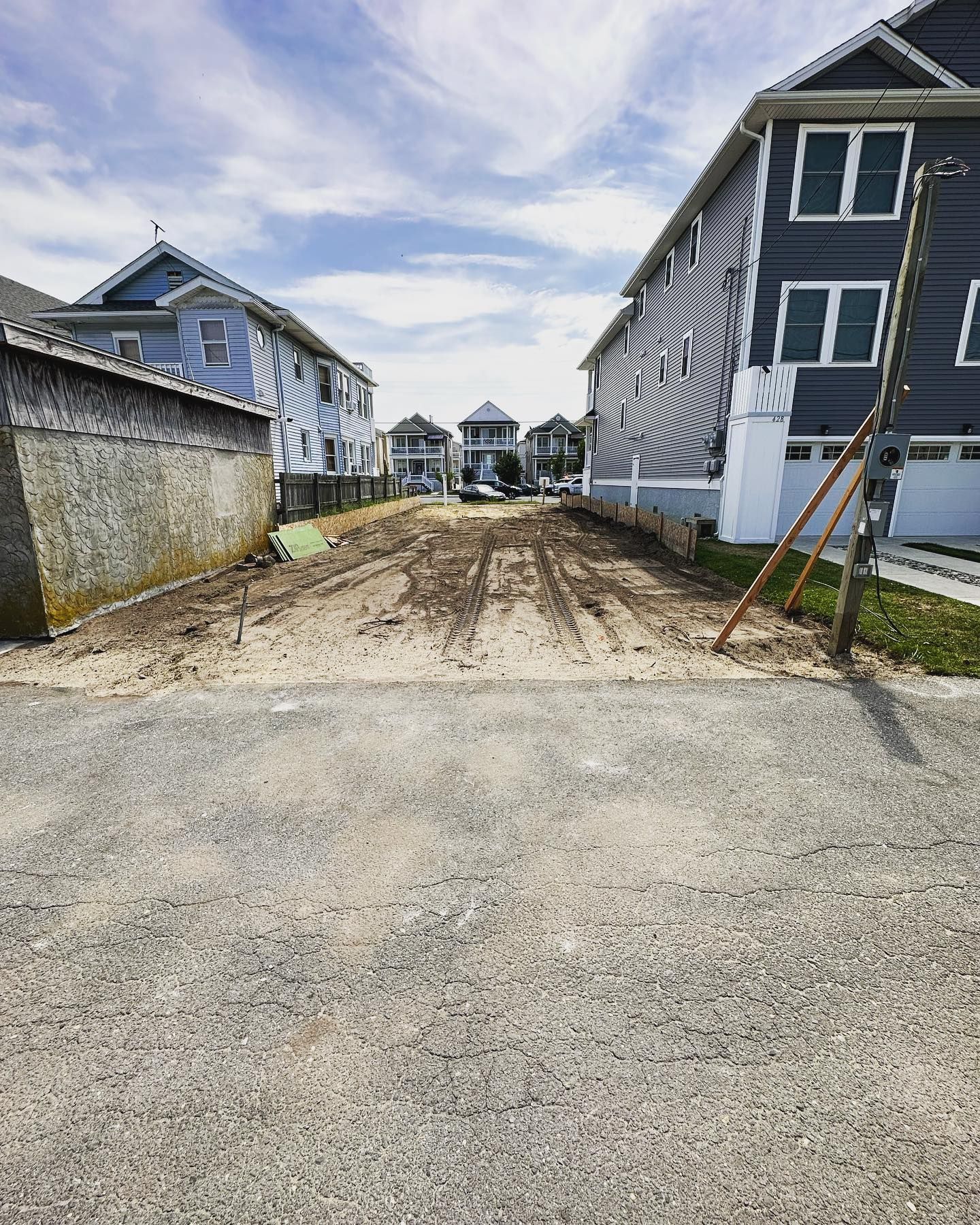 A dirt road leading to a row of houses