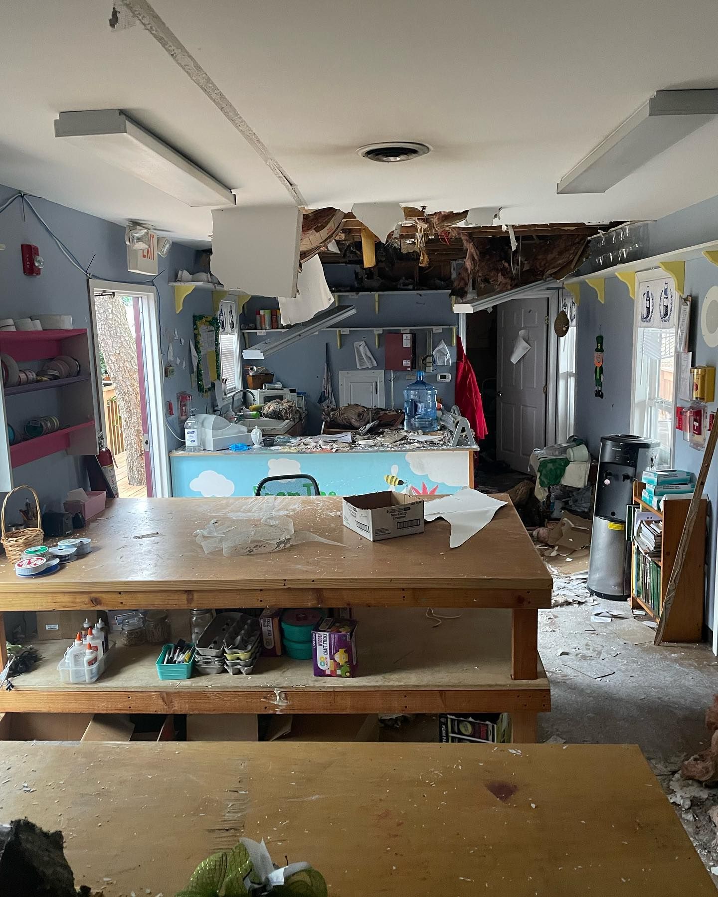 A messy room with a ceiling that has fallen down