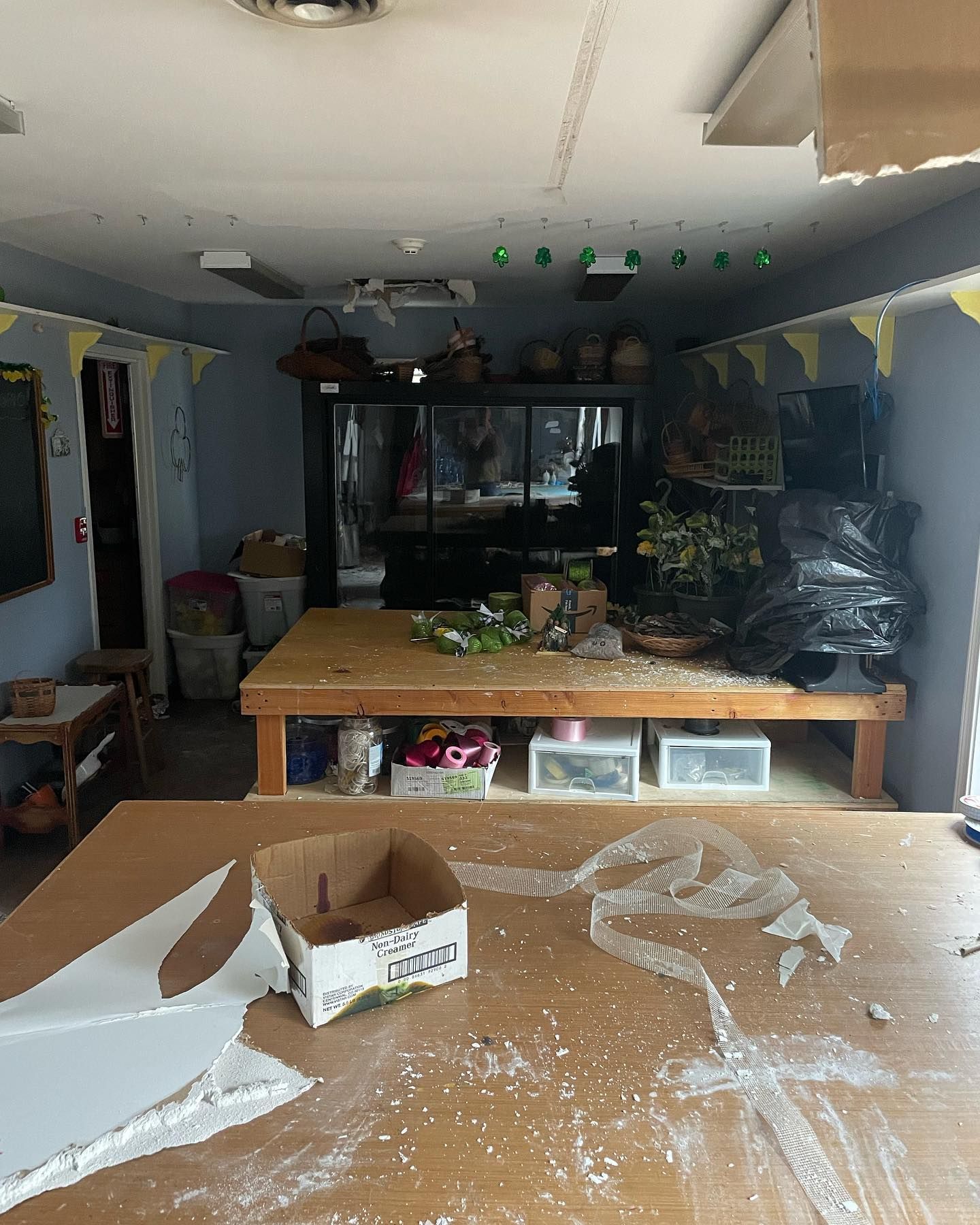 A messy room with a cardboard box that says i love you on it