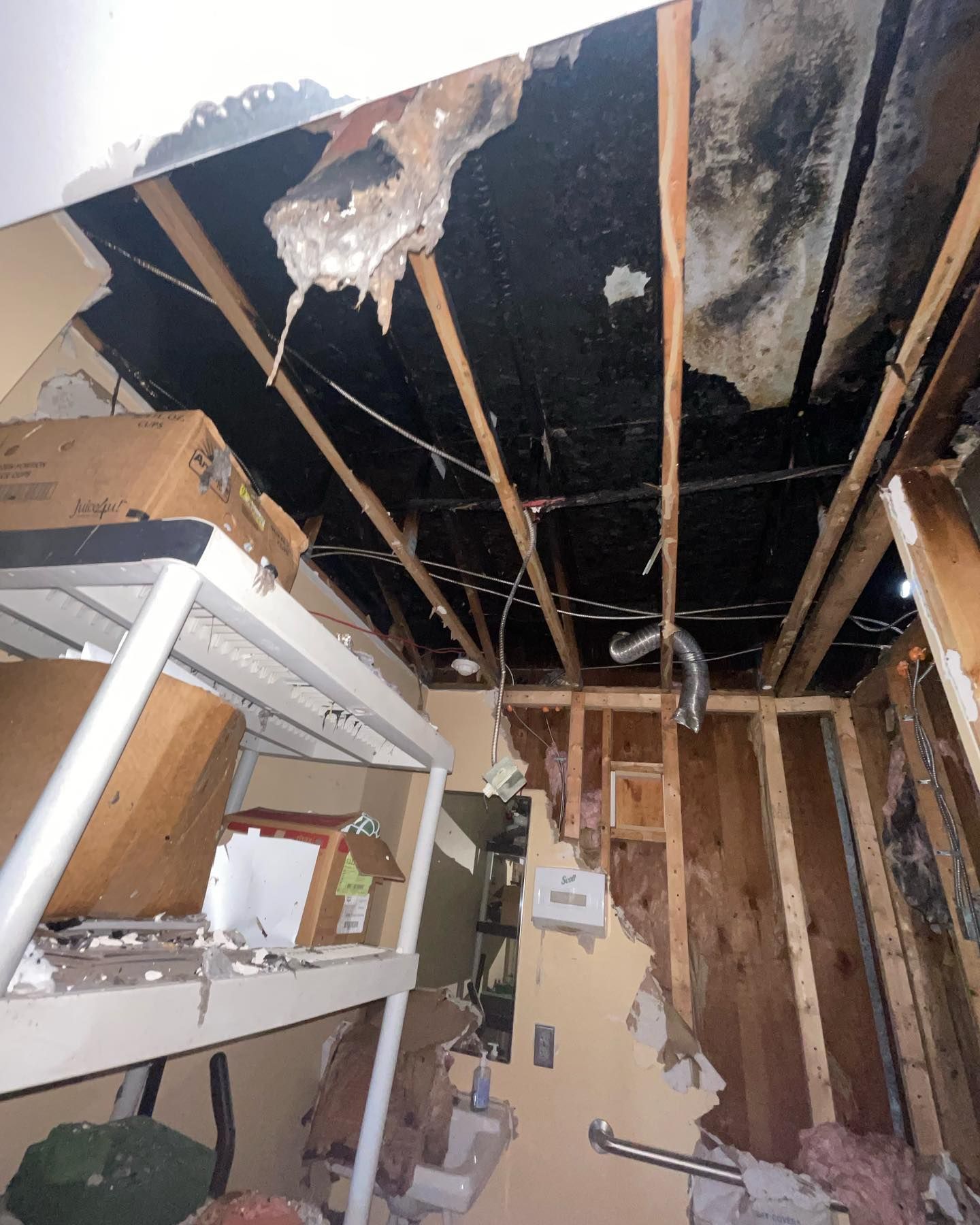 A room with a ceiling that has a hole in it