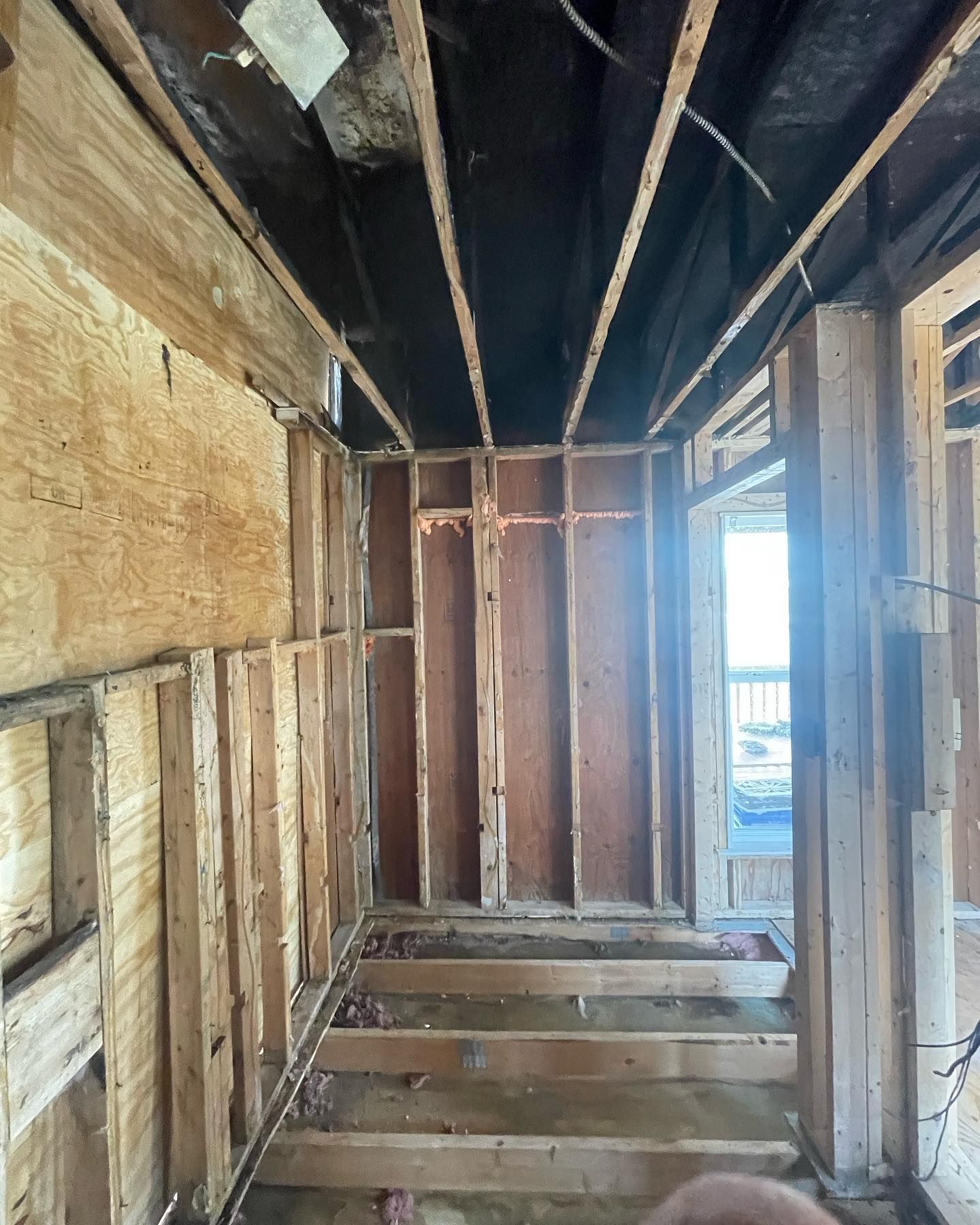 A room with a lot of wooden walls and a ceiling