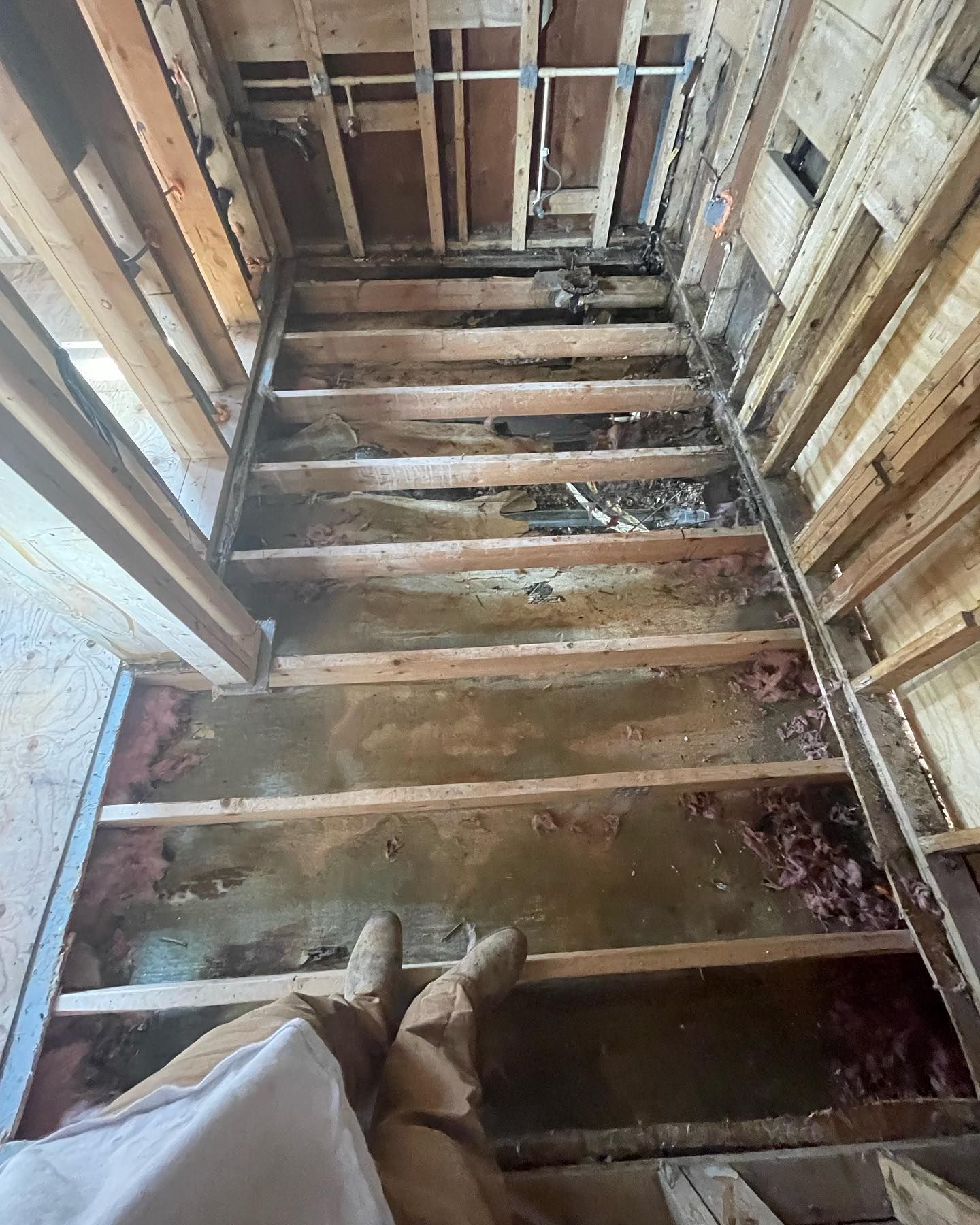 A person is standing on the floor of a building under construction