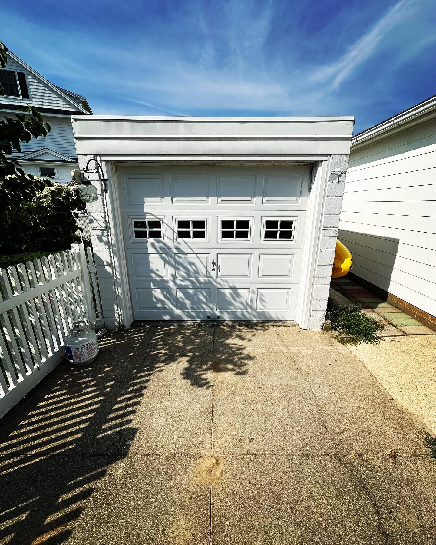 A white garage with a blue sky in the background