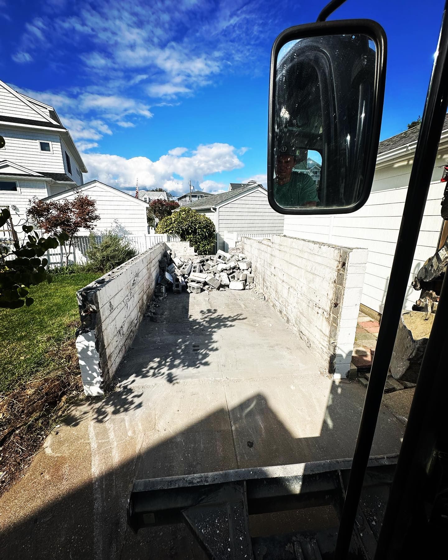 A truck is parked in front of a white house