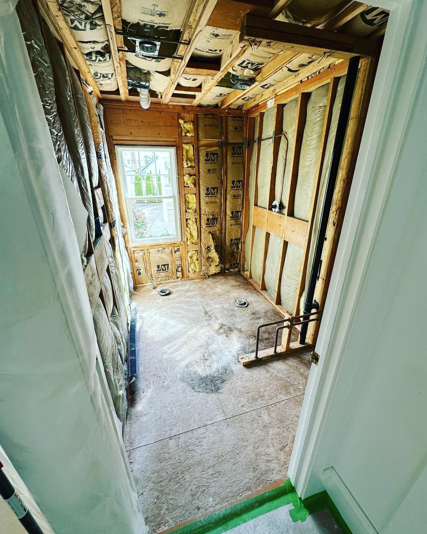 A room that is being remodeled with a green tape on the floor