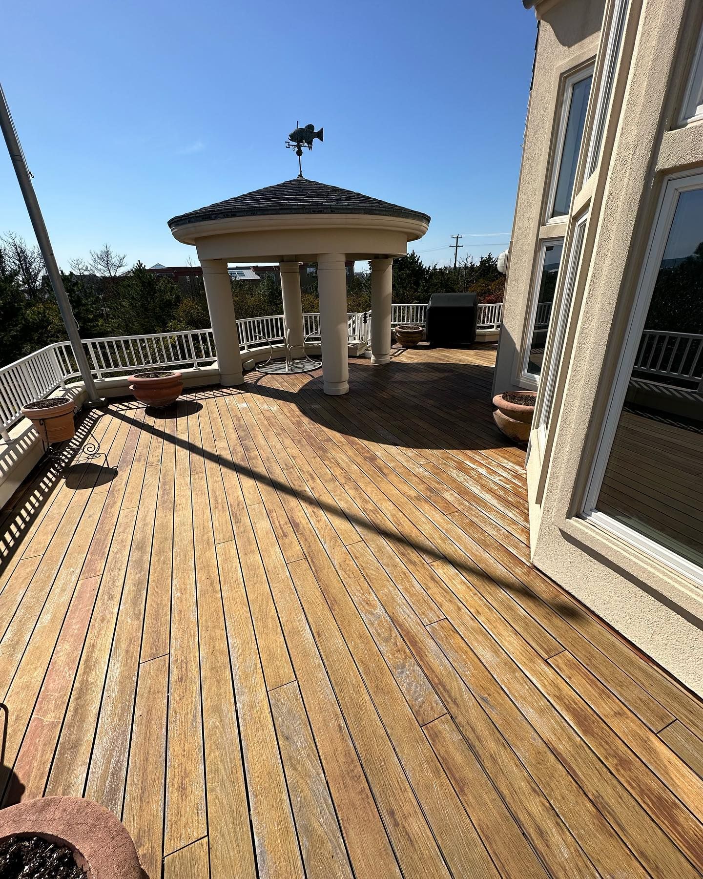A wooden deck with a gazebo on top of it