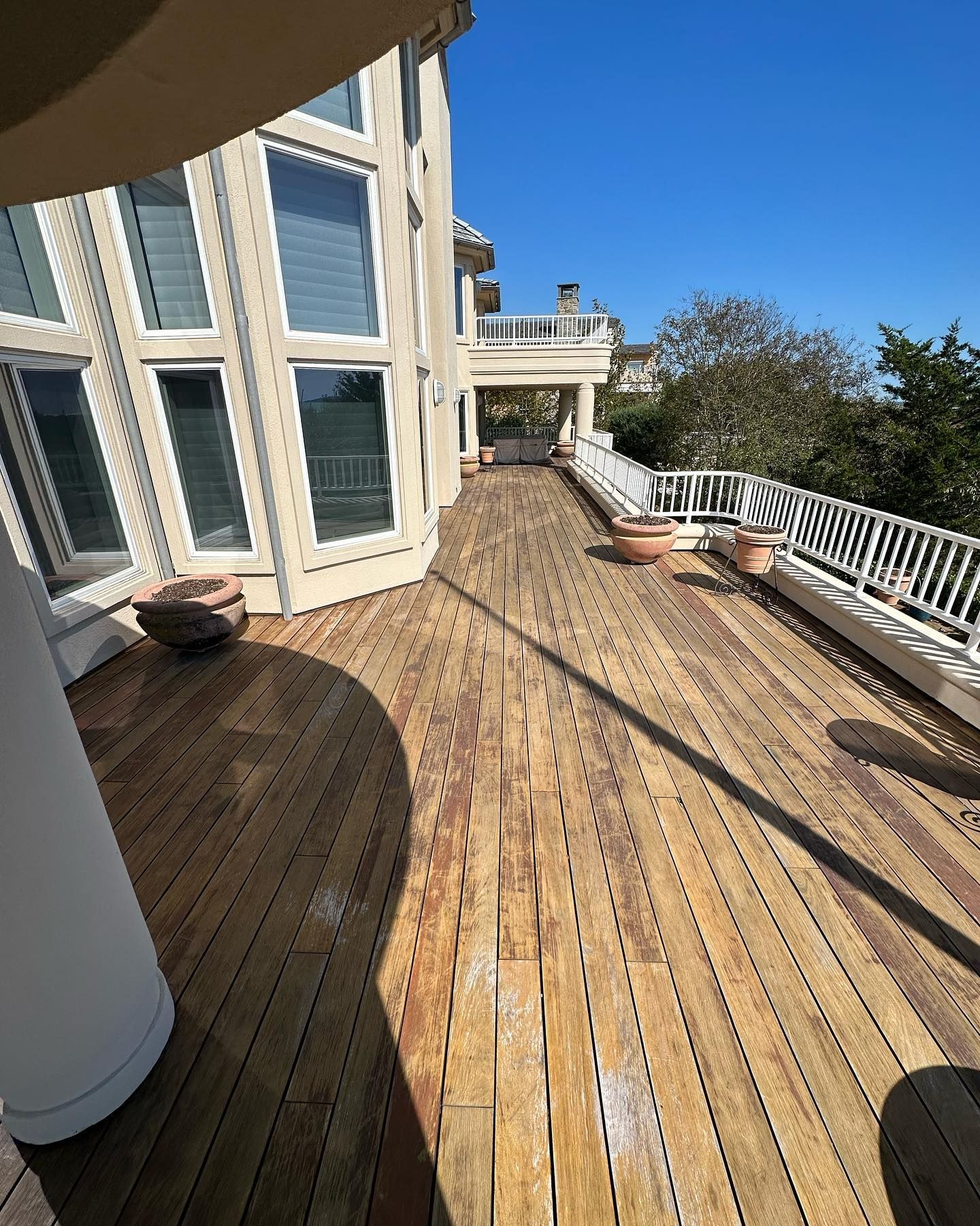 A large house with a large wooden deck in front of it