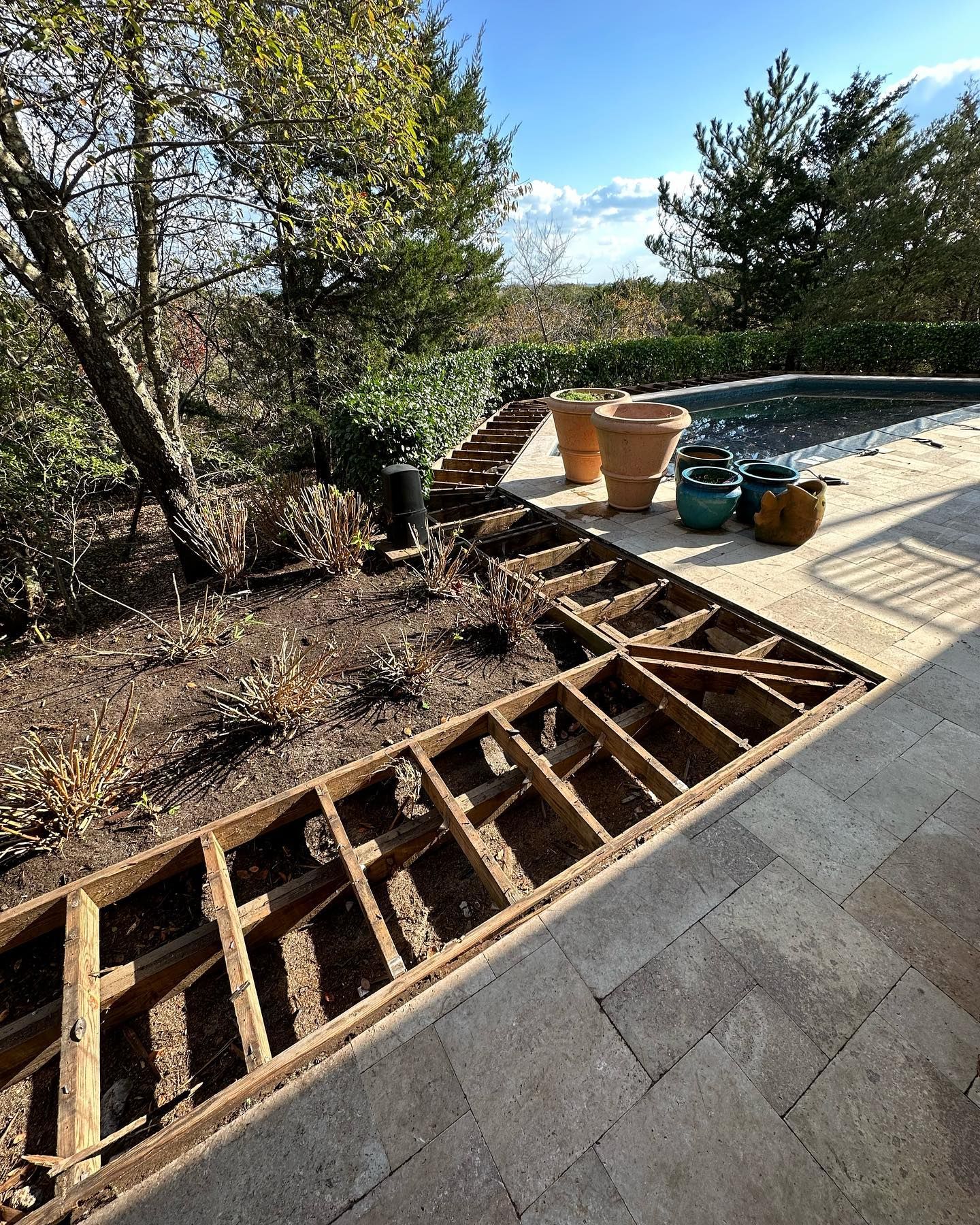A wooden deck is being built next to a swimming pool