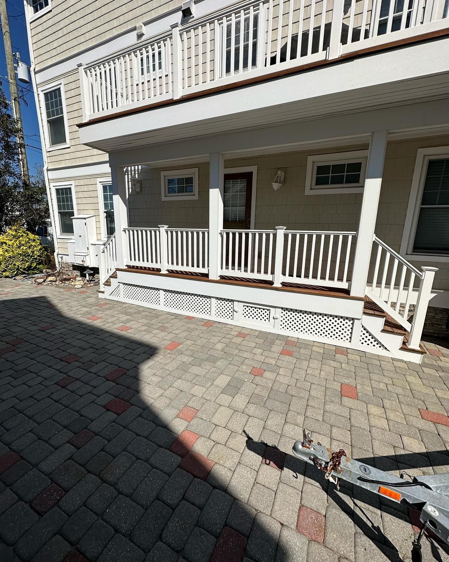 A house with a large porch and a white railing