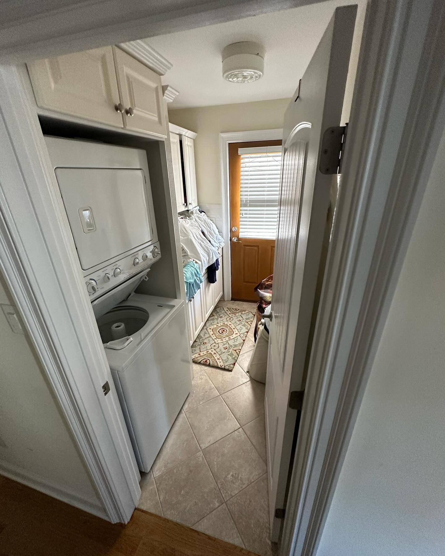 A laundry room with a washer and dryer stacked on top of each other