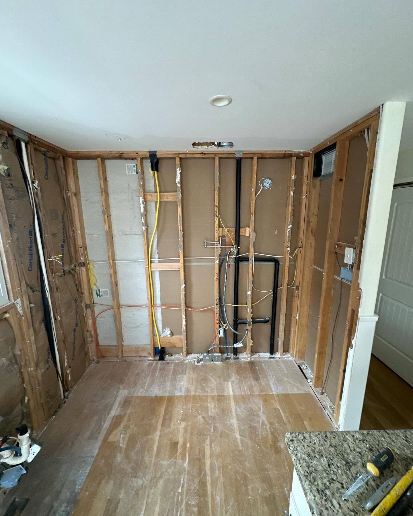 A room that is being remodeled with wooden walls