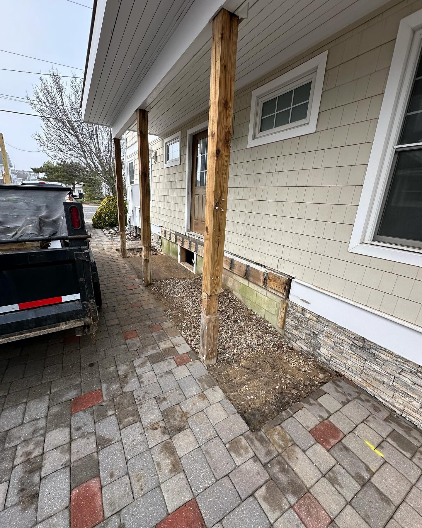 A black truck is parked in front of a house