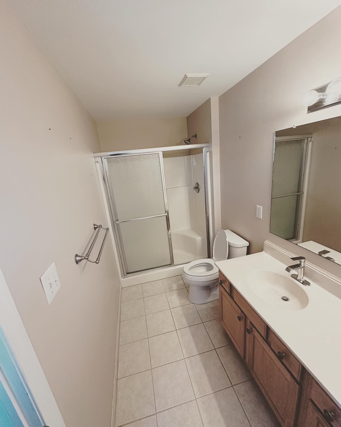 A bathroom with a toilet a sink and a shower