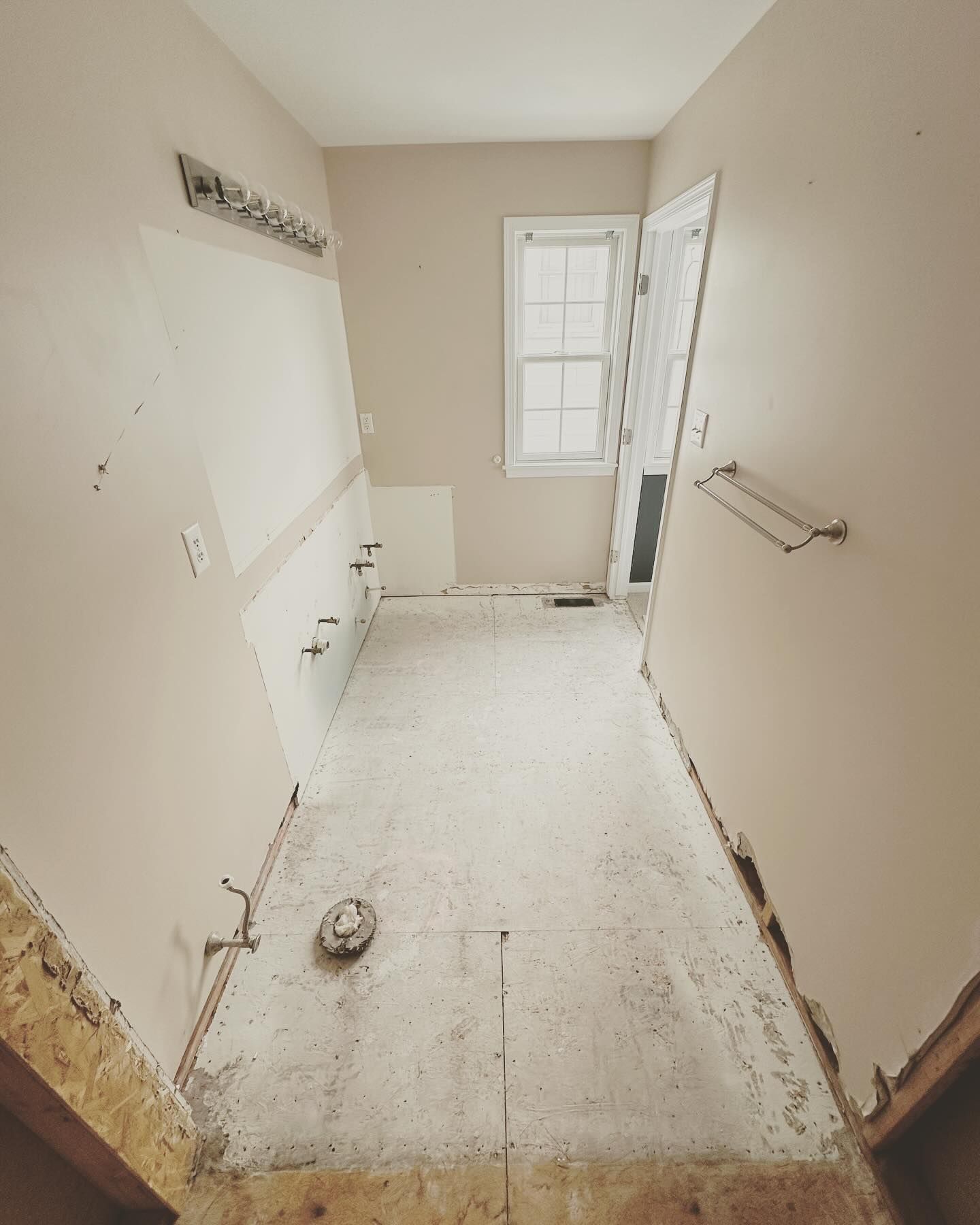 A bathroom that is being remodeled with a window