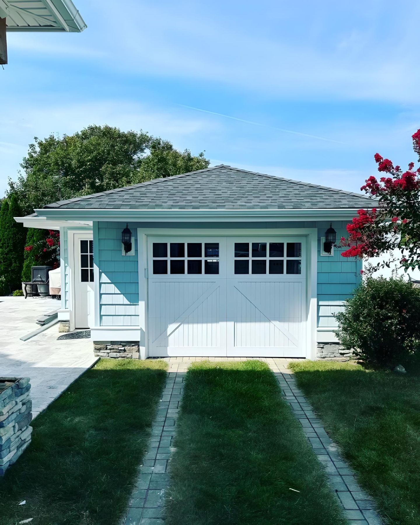 A blue house with a white garage door