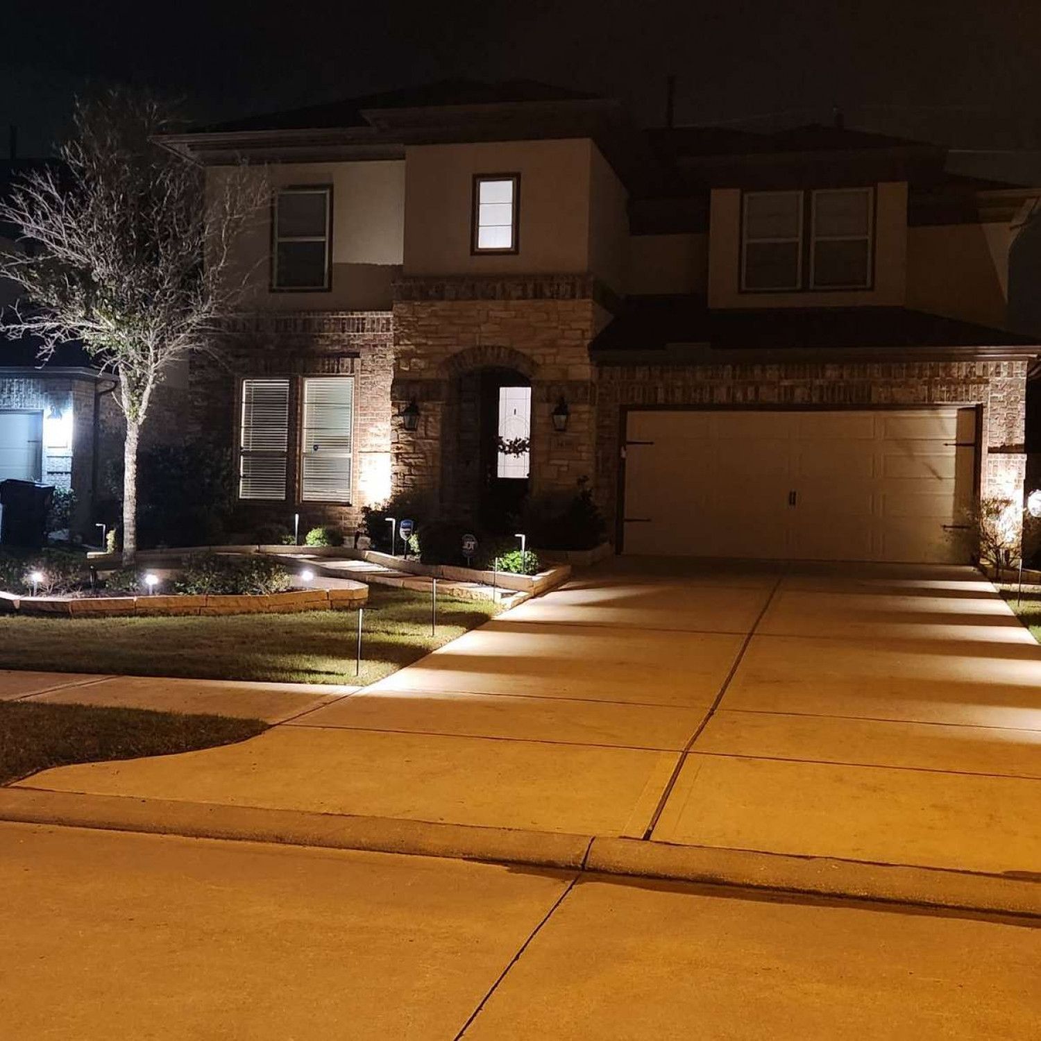 The front of a house is lit up at night