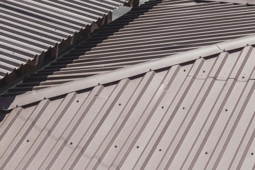Brown Corrugated Metal Roof. Sections Meet at an Angle — Coffs Coast Roofing In Mullaway, NSW