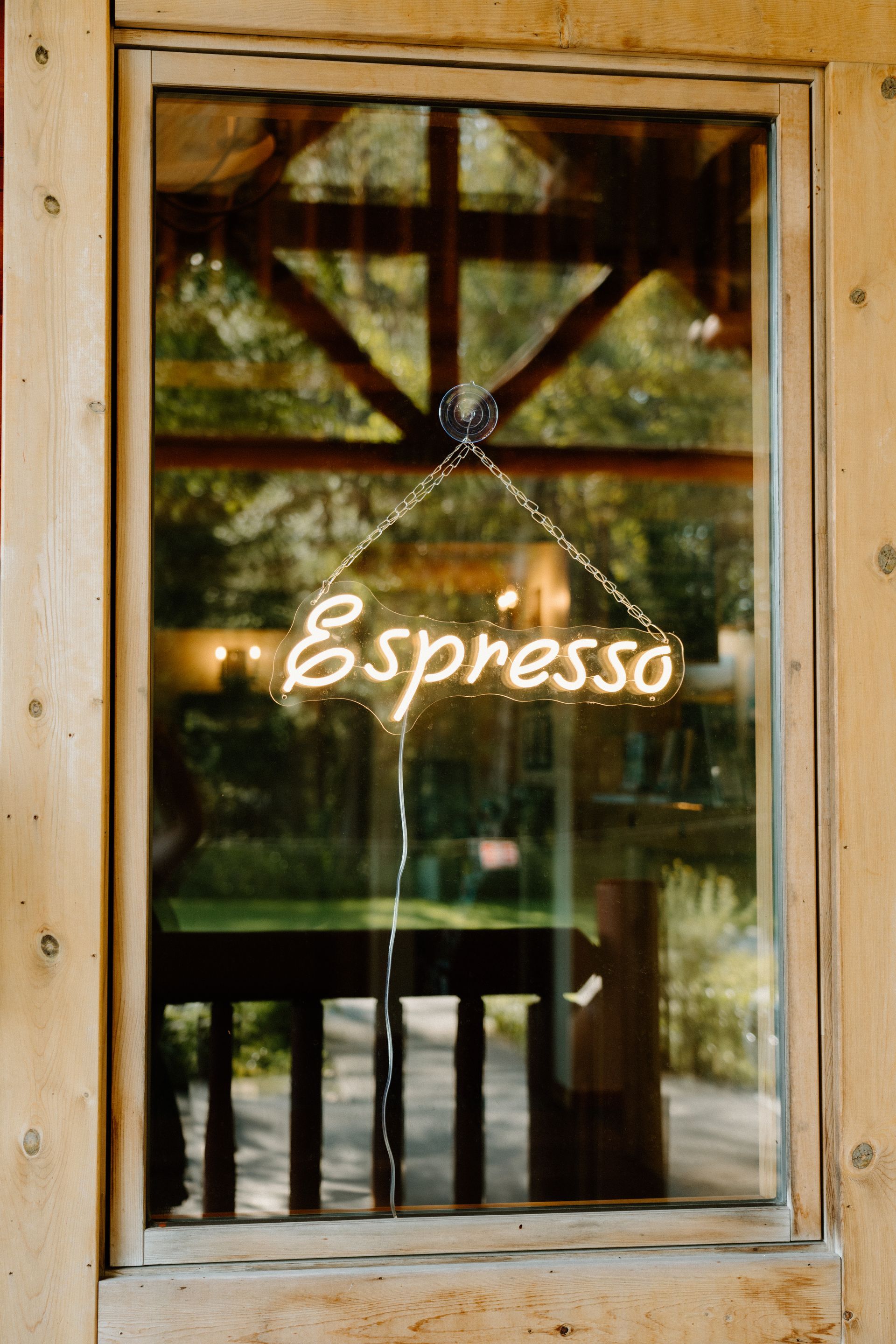 A window with a sign that says espresso on it