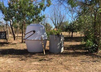Two White Buckets Are Sitting on the Ground in a Field — Fastcall Group In Herbert, NT