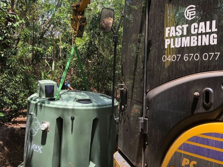 A Large Green Tank is Being Lifted by a Crane — Fastcall Group In Herbert, NT