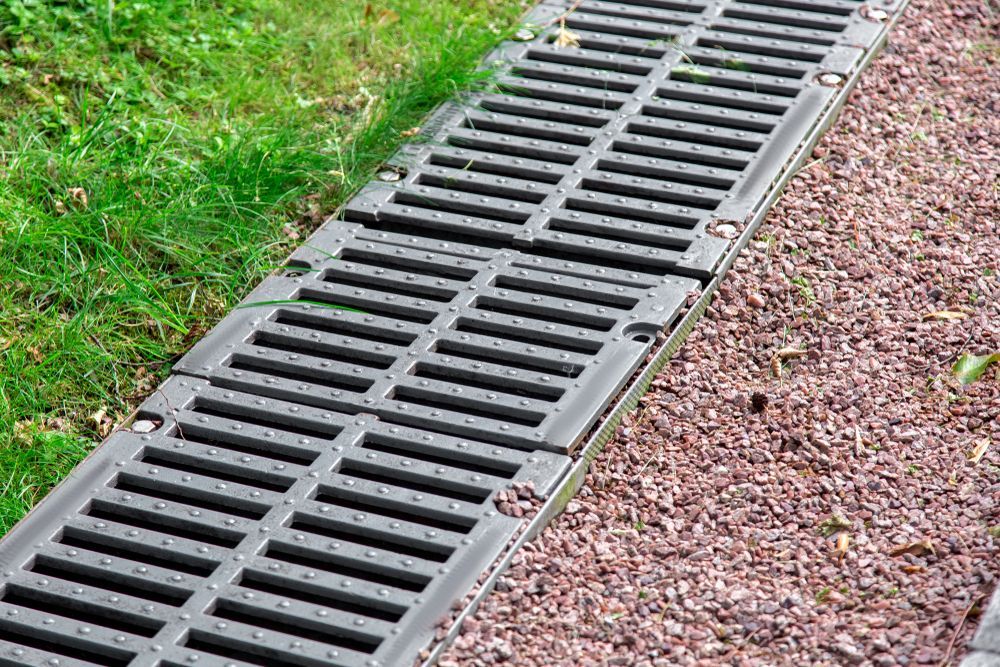 A Manhole Cover is Sitting on Top of a Gravel Path — Fastcall Group In Herbert, NT