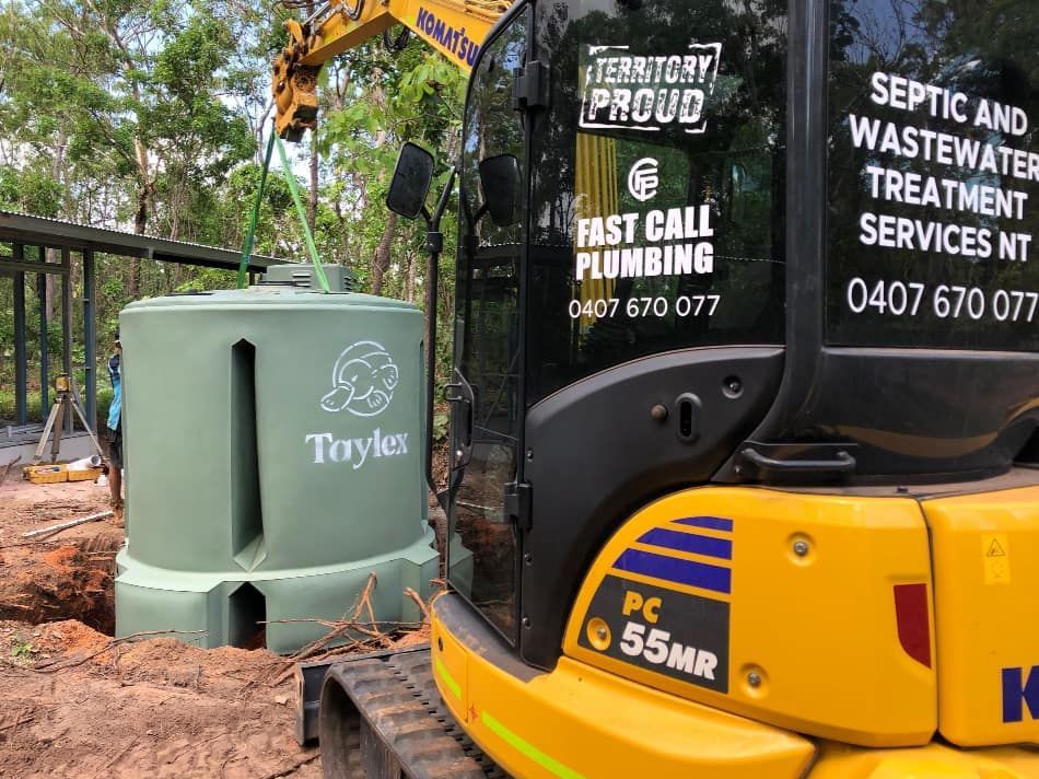A Yellow Excavator is Being Used to Install a Septic Tank — Fastcall Group In Herbert, NT