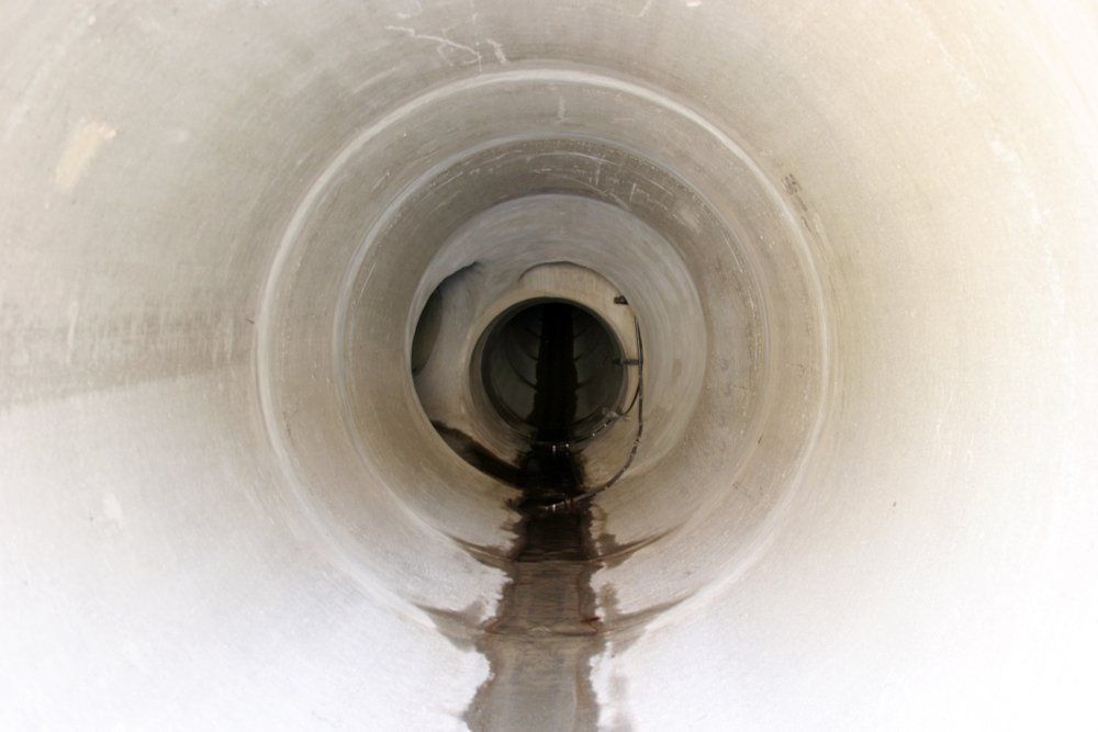A Close Up of a Drain Pipe With Water Coming Out of It — Fastcall Group In Herbert, NT