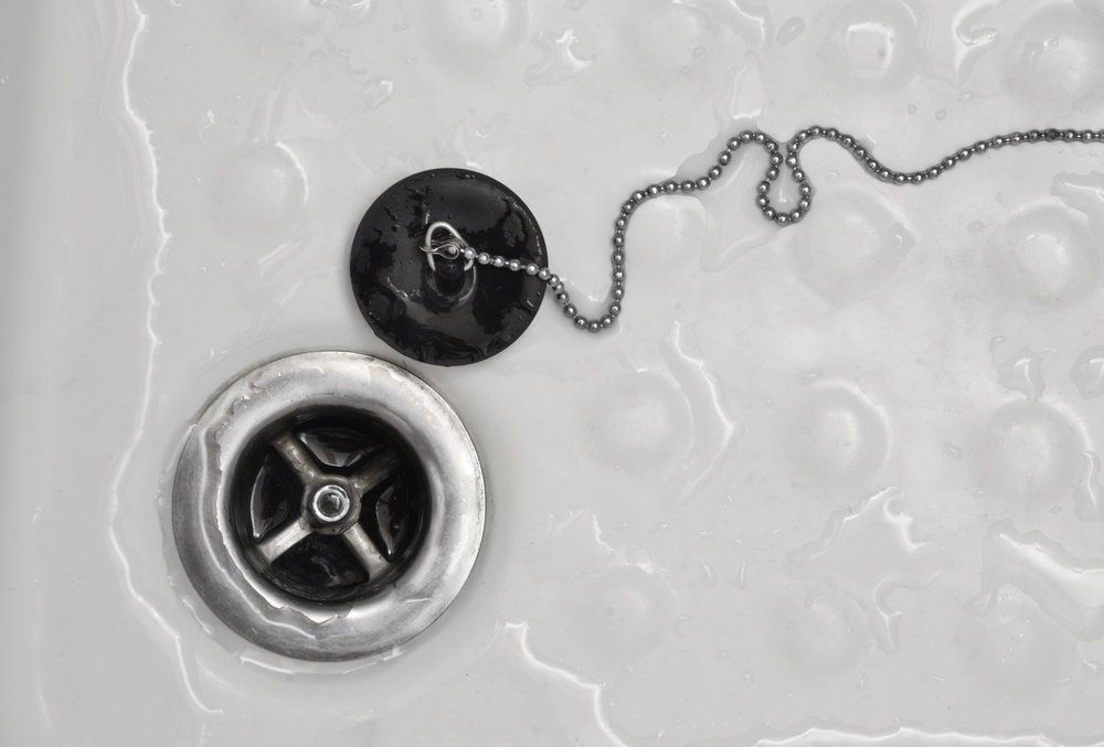 A Close Up of a Sink Drain With a Chain Coming Out of It — Fastcall Group In Herbert, NT