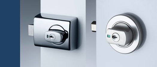 A close up of a door lock on a white door.