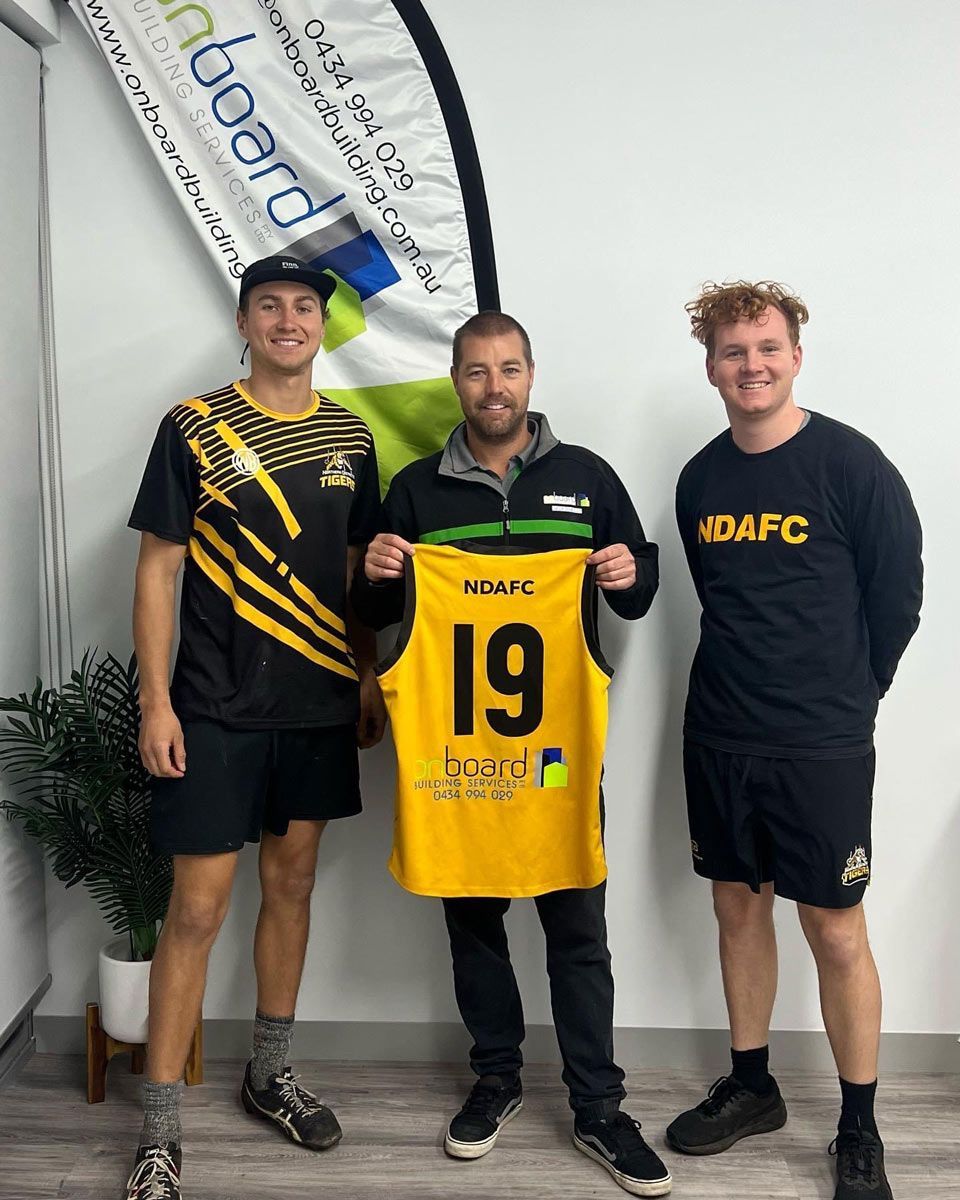 Three Men Wearing Black Tops With Flexing Yellow Jersey — Promotional Apparel In Woonona, NSW