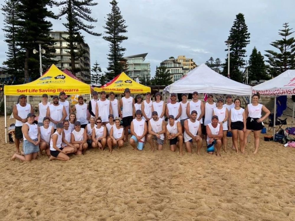Group Of People Wearing White Shirt With Tents Background — Promotional Apparel In Shellharbour, NSW