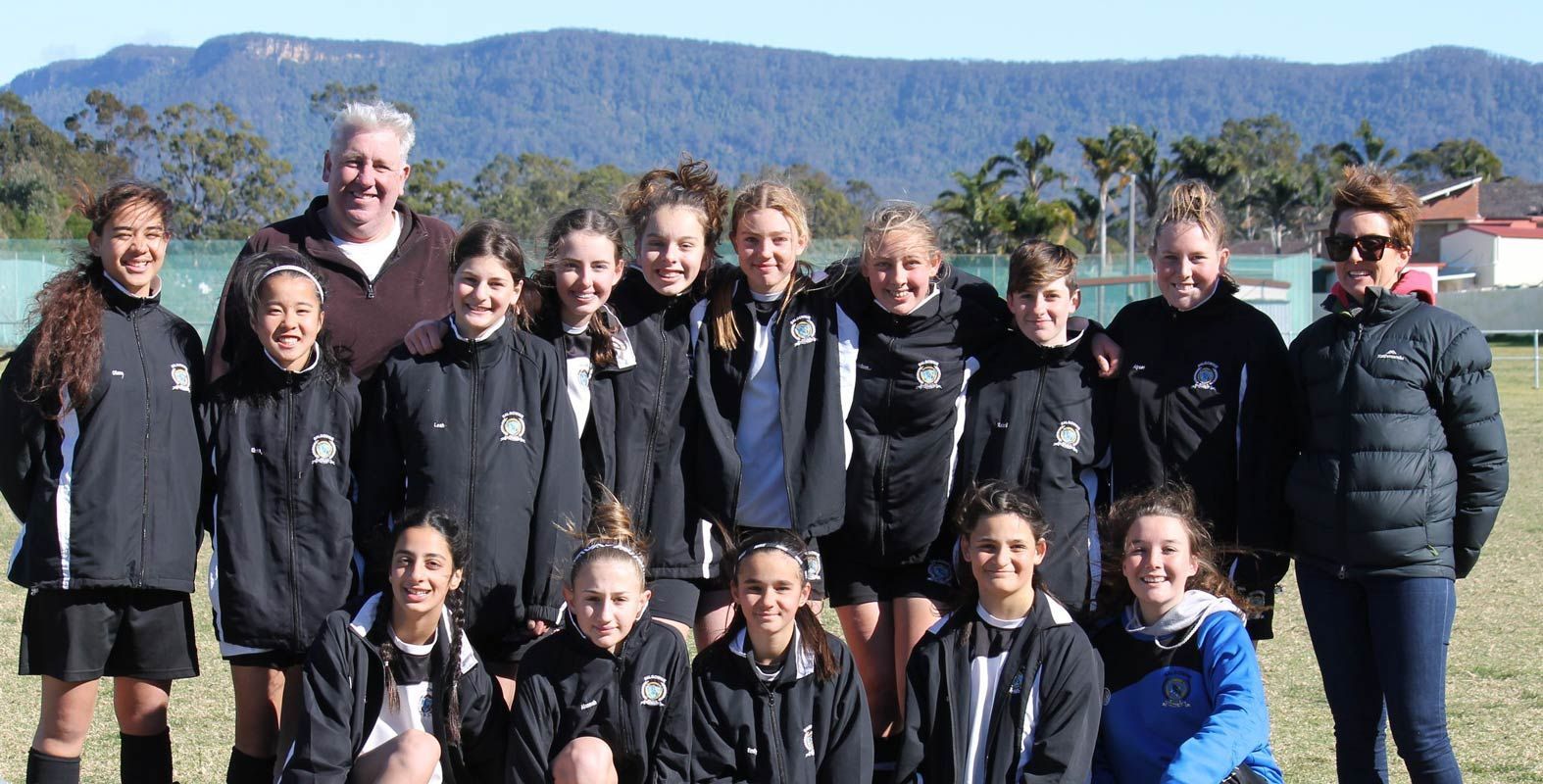 Group Of People Wearing Printed Jackets With Mountain Background — Promotional Apparel In Kiama, NSW