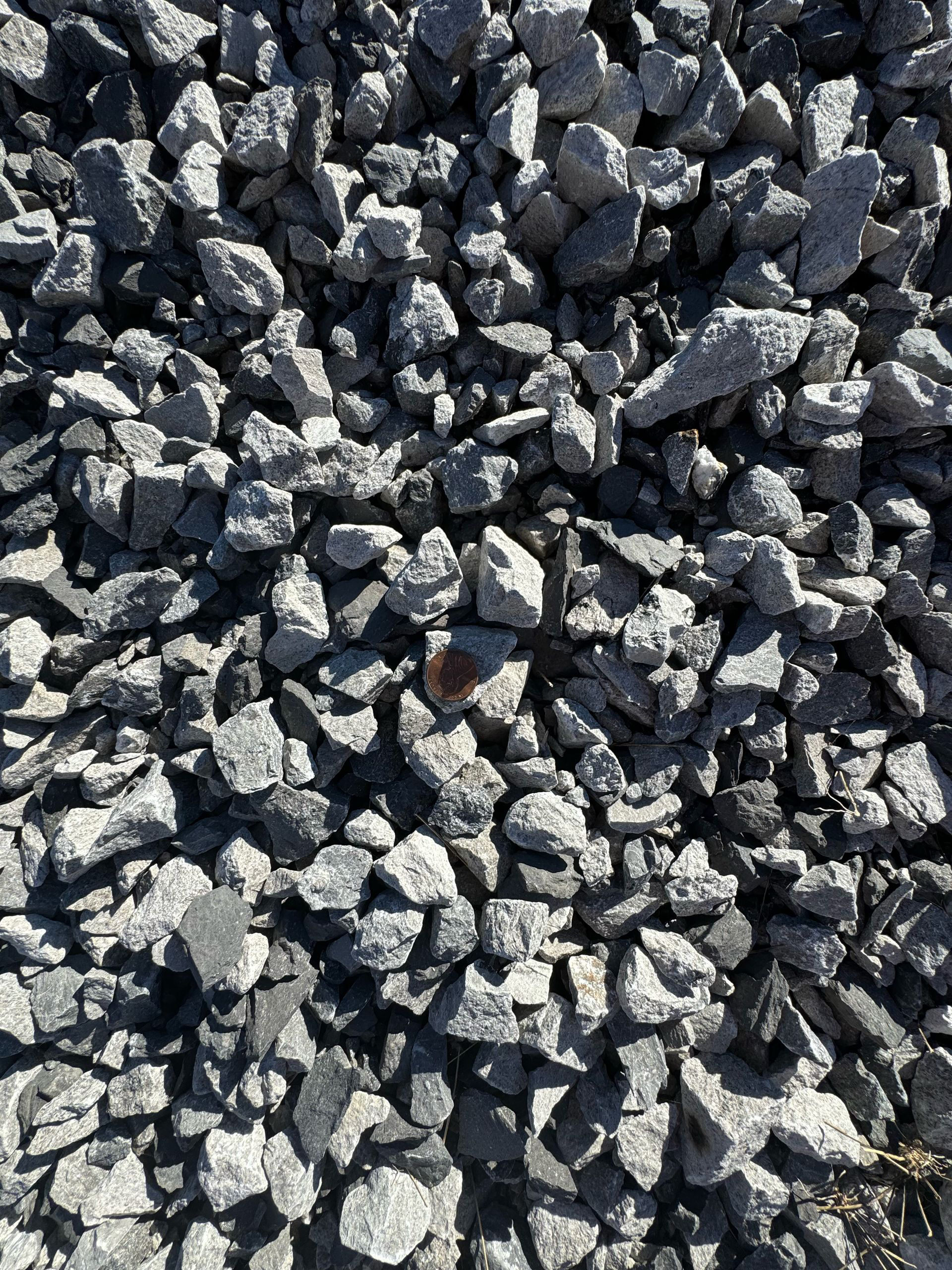 A pile of rocks with a penny in the middle A pile of rocks with a penny in the middle