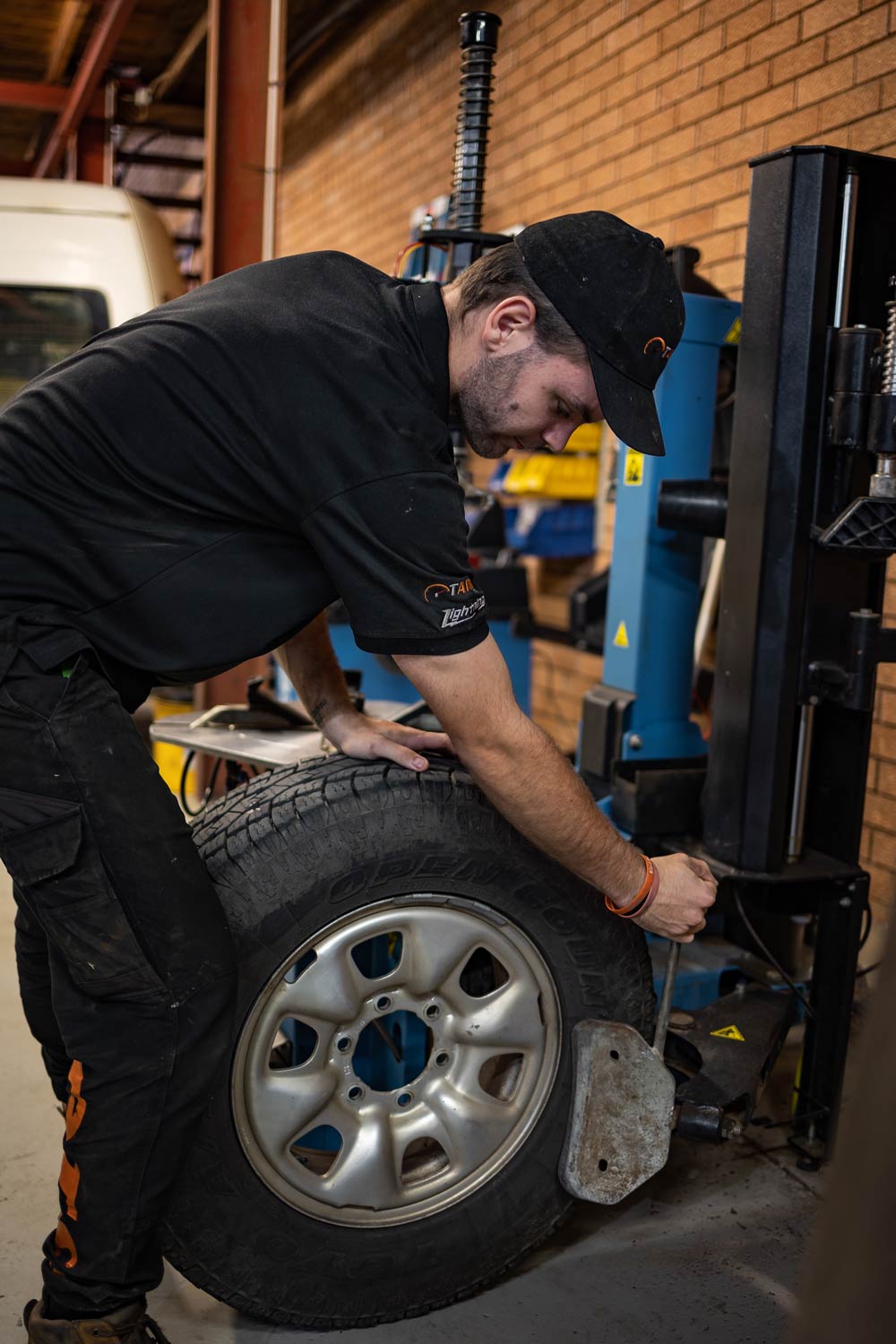 Mechanic removing Tire — Stock & Fit Car Tyres in Dubbo, NSW