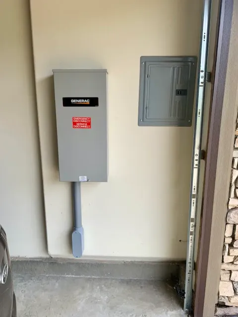 Electrical panel and breaker box on a beige wall in a garage.