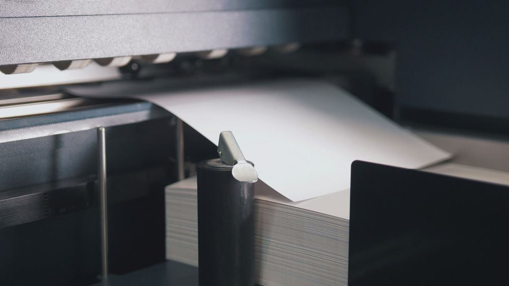 Printing Machine Takes Sheet Of Paper — Graphic Designer In Moranbah, QLD