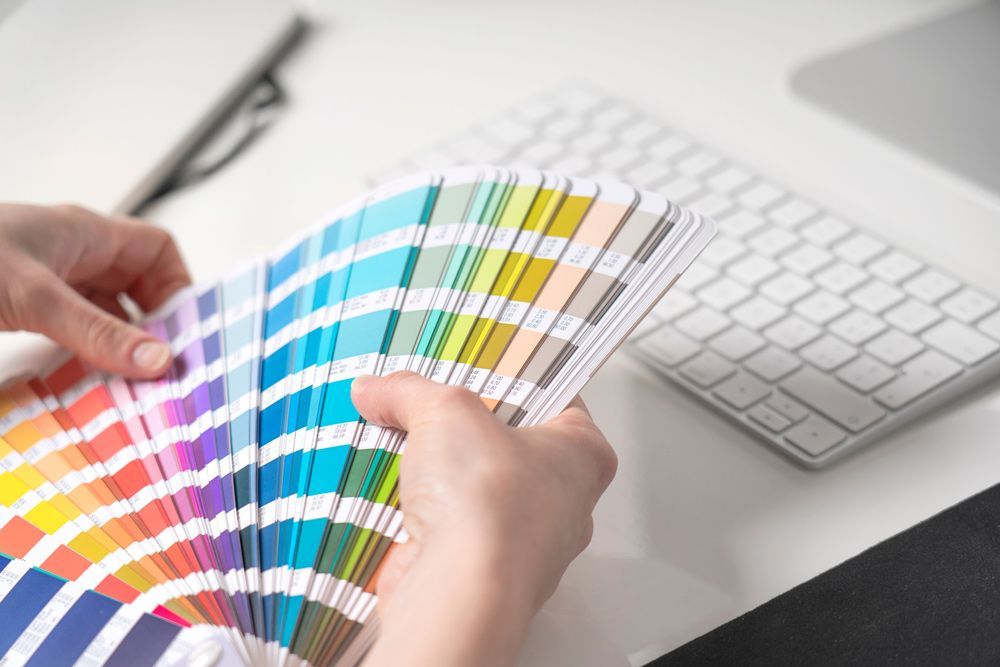Graphic Designer Chooses Colors From Palette Guide — Graphic Designer In Nowra, QLD
