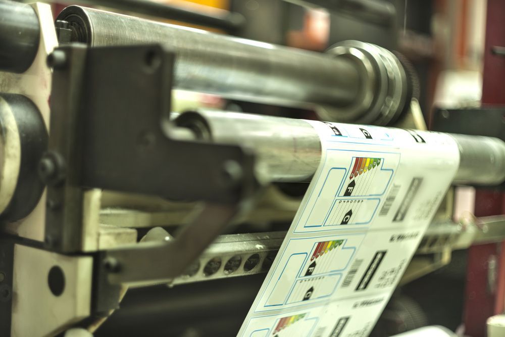 Printing Machine Running A Long Roll Off Paper — Graphic Designer In Nowra, QLD