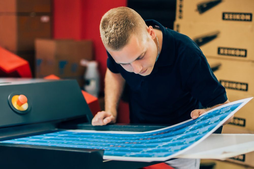 Man Working In Printing Shop — Graphic Designer In Airlie Beach, QLD