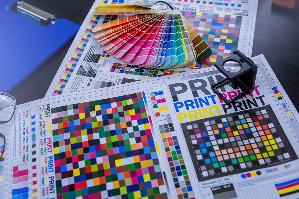 Magnifying Glass And Color Palette On The Table — Graphic Designer In Wollongong, QLD