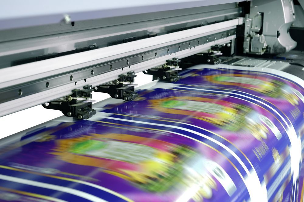 Printing Machine Printing Colored Images — Graphic Designer In Nowra, QLD
