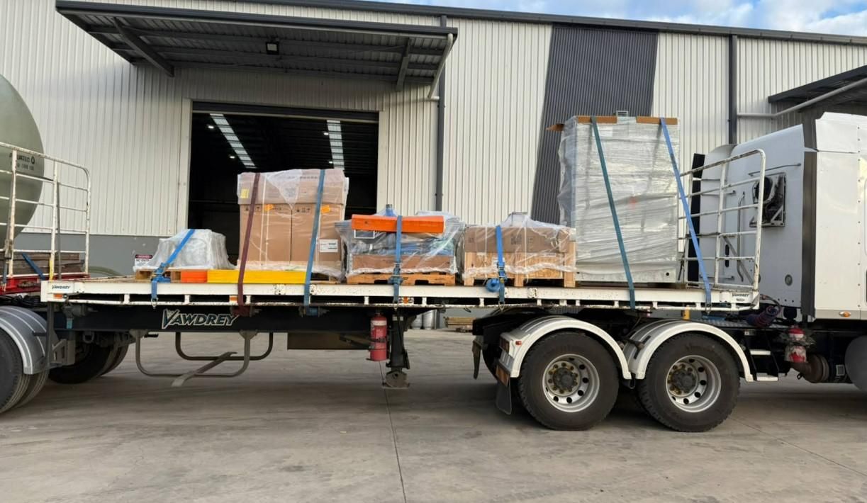 A Truck is Parked in Front of a Building With Boxes on the Back of It — Goulburn Transport In Southern Highlands, NSW