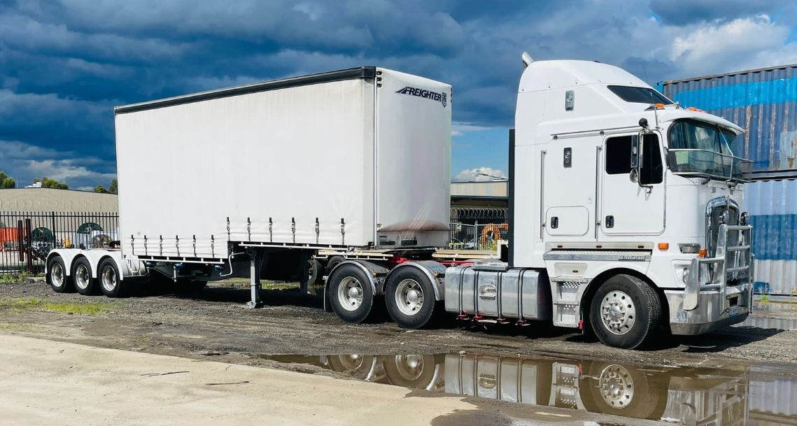 A White Semi Truck With a Trailer Attached to It is Parked — Goulburn Transport In Melbourne, VIC
