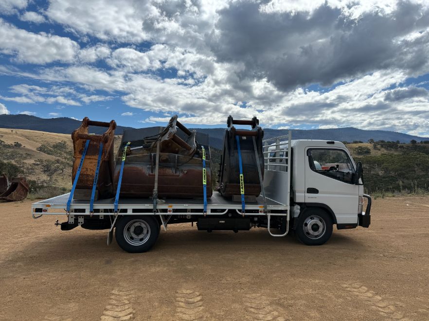 A White Truck is Sitting on Top of a Dirt Field — Goulburn Transport In Sydney, NSW