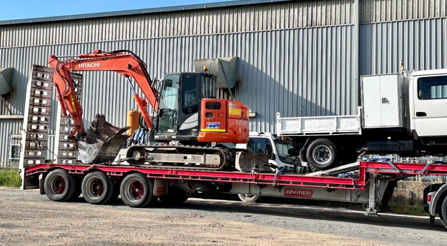 A Truck is Carrying an Excavator and a Dump Truck — Goulburn Transport In Goulburn, NSW