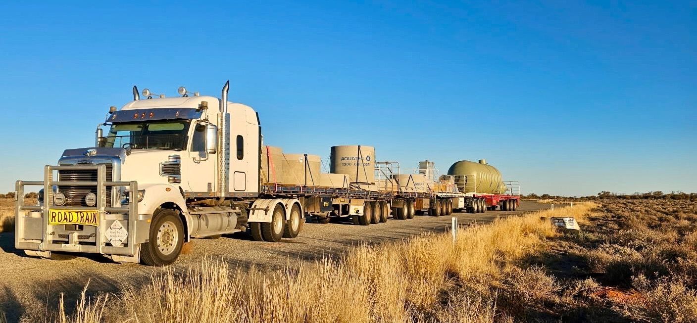 A Semi Truck is Parked in a Parking Lot Next to a Building — Goulburn Transport In Goulburn, NSW