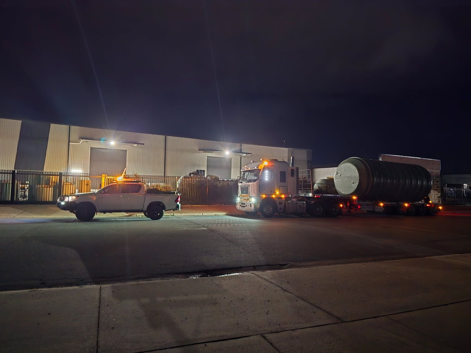 A ute is leading a truck at night — Goulburn Transport In Brisbane, QLD