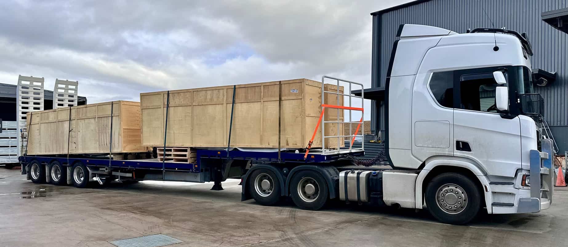 A truck is carrying wooden boxes in the trailer — Goulburn Transport In Goulburn, NSW