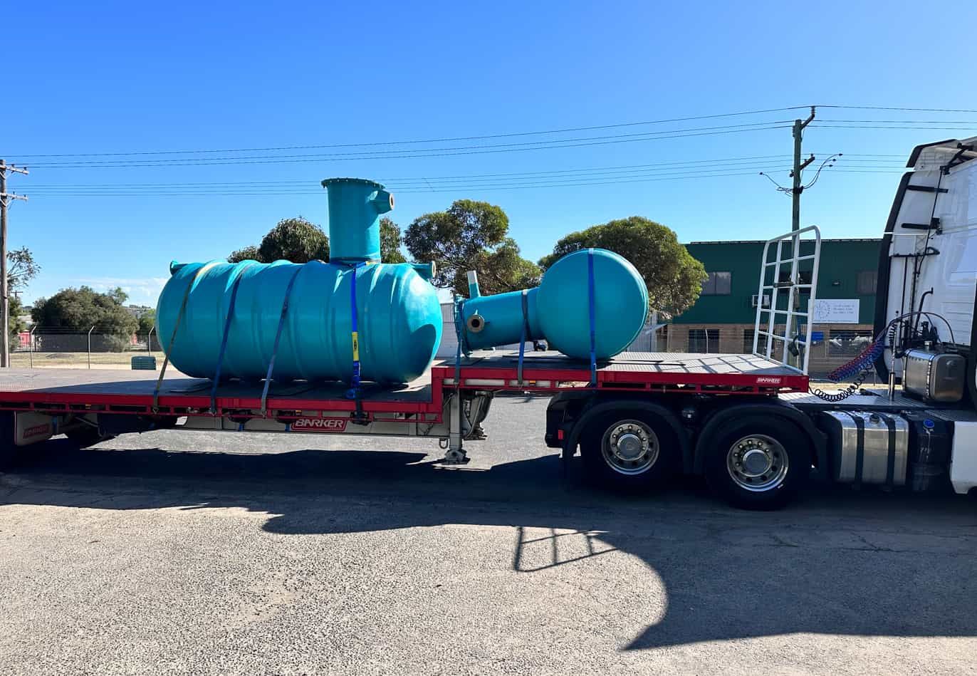 A Large Blue Tank is Being Transported on a Semi Truck — Goulburn Transport In Southern Highlands, NSW
