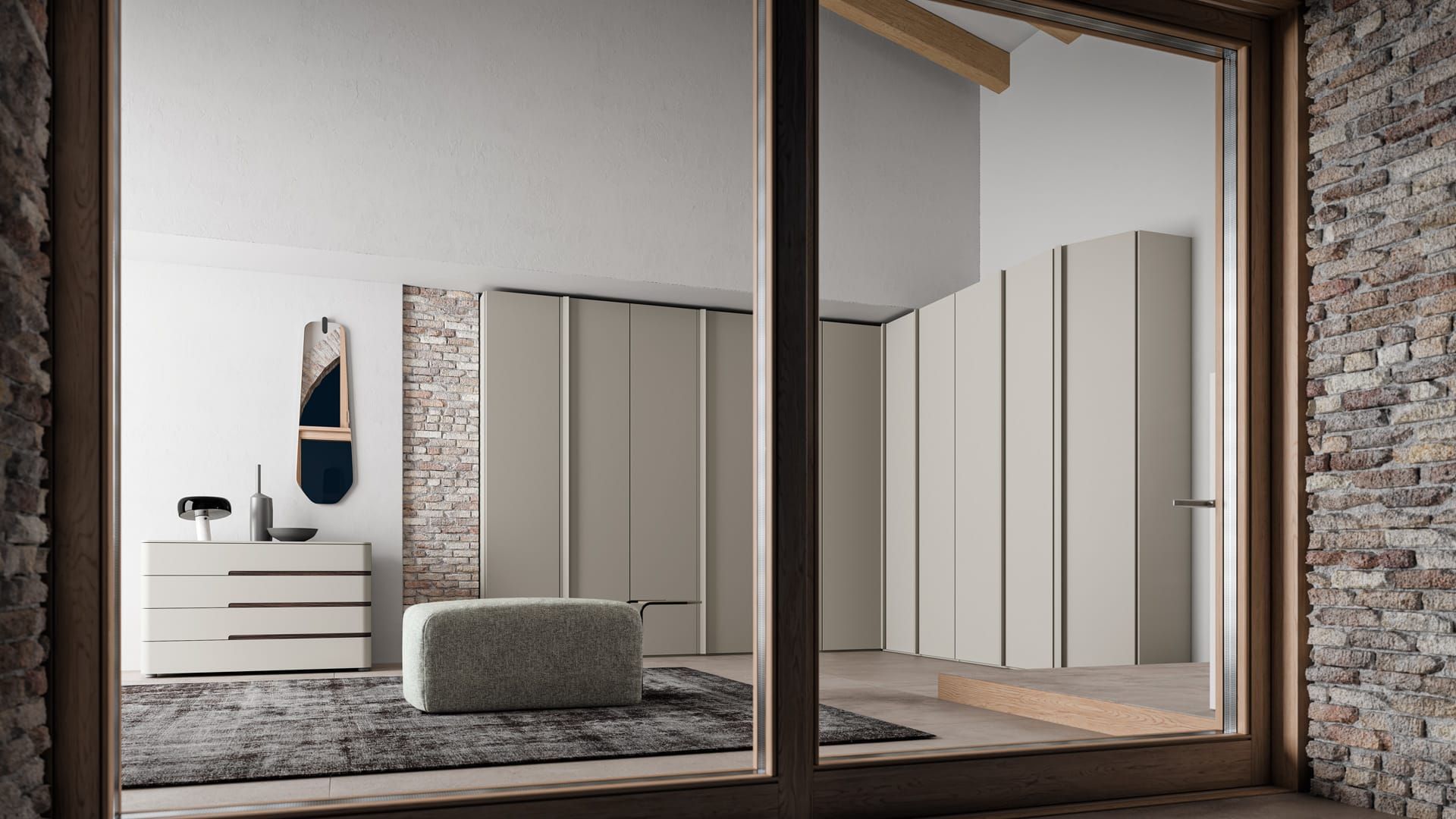 Camera da letto moderna con ampie finestre, letto grigio, armadio, cassettiera e parete decorativa in pietra.